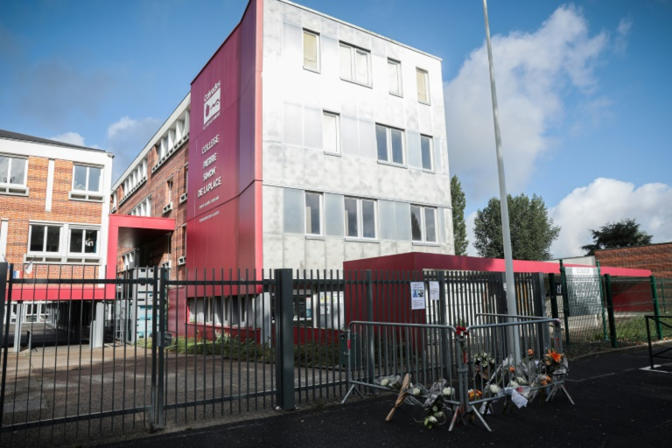 Des fleurs déposées devant le collège Pierre-Simon de Laplace dont le principal a été retrouvé mort dans des conditions suspectes, le 12 août 2023 à Lisieux dans le Calvados © LOU BENOIST