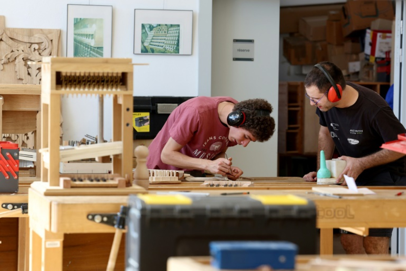 Des apprentis travaillent sur la maquette d'un orgue au Centre de formation de la facture d'orgue à Eschau, dans l'est de la France, le 5 septembre 2023 © FREDERICK FLORIN