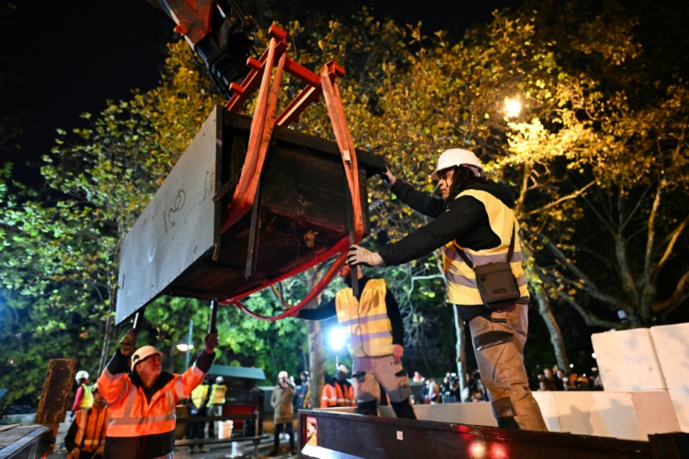 La boîte d'un bouquiniste est soulevée par une grue le 17 novembre 2023 à Paris lors d'un test de faisabilité de démontage en prévision des JO © Miguel MEDINA