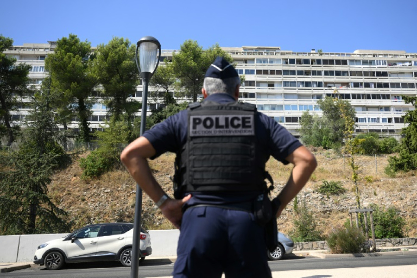 Un policier monte la garde dans le quartier de Pissevin, à Nîmes, le 22 août 2023 après la mort d'un garçon de 10 ans, victime collatérale du trafic de drogue © NICOLAS TUCAT