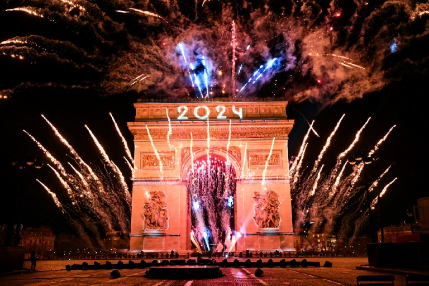 Des personnes se rassemblent sur l'avenue des Champs-Elysées pour les célébrations du Nouvel An à Paris, le 31 décembre 2023 © Bertrand GUAY