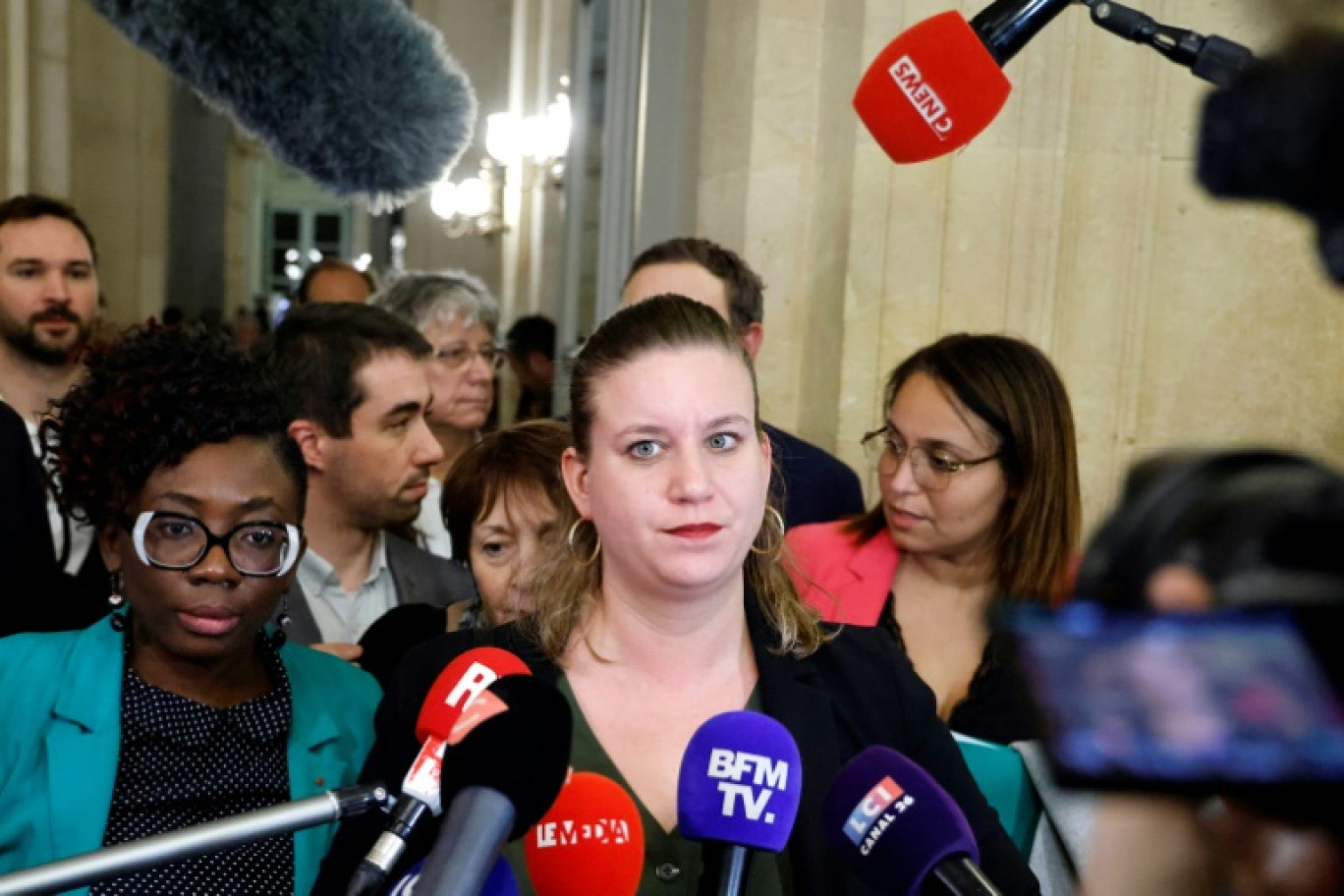 French leftist La France Insoumise (LFI) party Member of Parliament Daniele Obono (L) and president of La France Insoumise group at the French National Assembly Mathilde Panot (C) speak to the press following the vote and the approval of the draft law to control immigration, at the French National Assembly in Paris on December 19, 2023. A commission of upper house senators and lower house National Assembly MPs agreed a new draft of the flagship bill on immigration, which had been voted down without being debated in the National Assembly last week in a major blow to Macron. The legislation is now approved by the Senate and the National Assembly, on December 19, 2023. © Ludovic MARIN