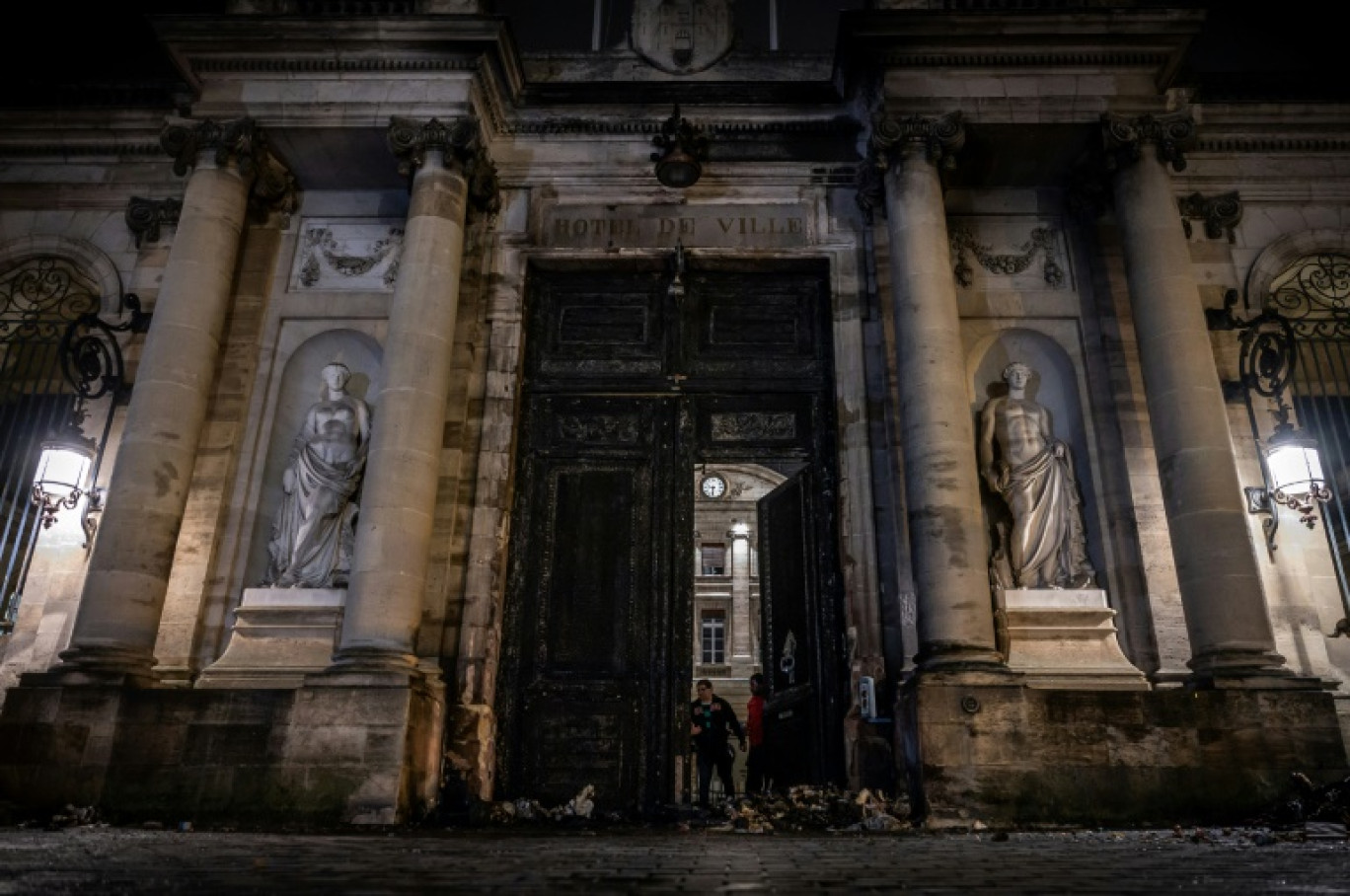 La porte en bois, vieille de plusieurs siècles, de l'hôtel de ville de Bordeaux, peu après avoir été incendiée, le 23 mars 2023 dans la foulée d'une manifestation contre la réforme des retraites © PHILIPPE LOPEZ