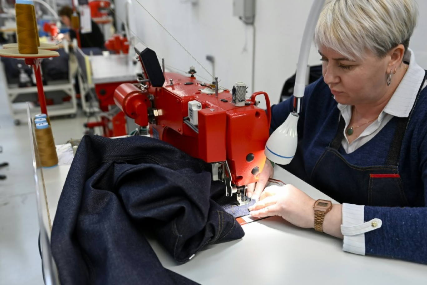 Une couturière coud un jean dans l'usine de la marque 1083 à Rupt-sur-Moselle, dans les Vosges, le 12 mars 2024 © Jean-Christophe VERHAEGEN