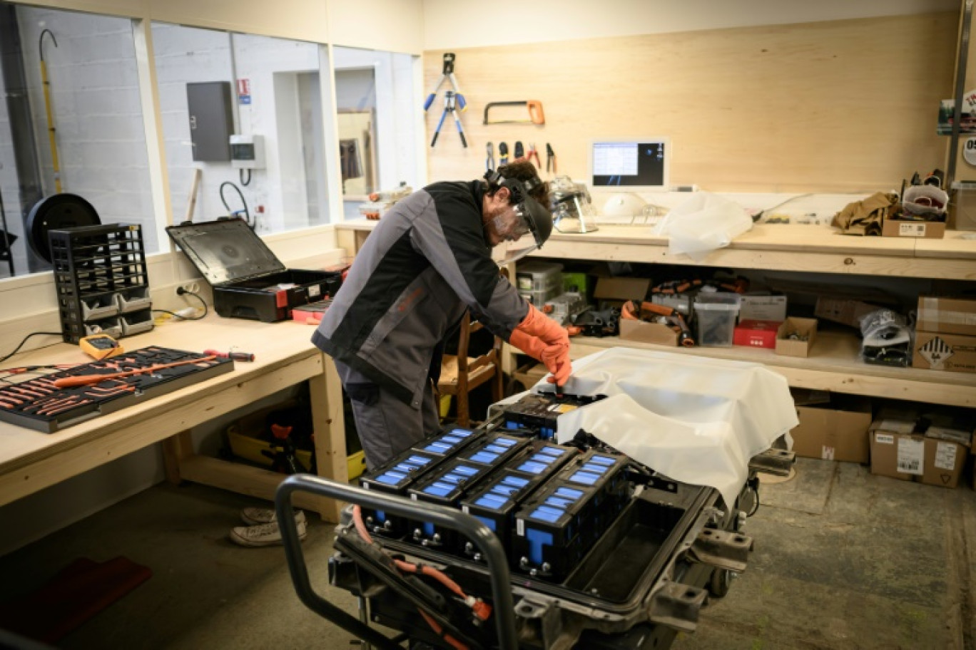 Un mécanicien travaille sur un module de batteries pour voiture électrique dans l'atelier de réparation spécialisé Revolte, à Carquefou (Loire-Atlantique), le 30 novembre 2022 © LOIC VENANCE