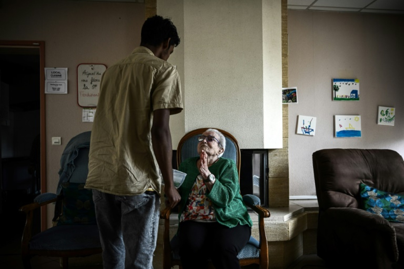 Un jeune migrant offre une morceau de pastèque à une personne âgée dans une résidence intergénérationnelle à Sciecq, dans les Deux-Sèvres, le 30 mai 2024 © Philippe LOPEZ