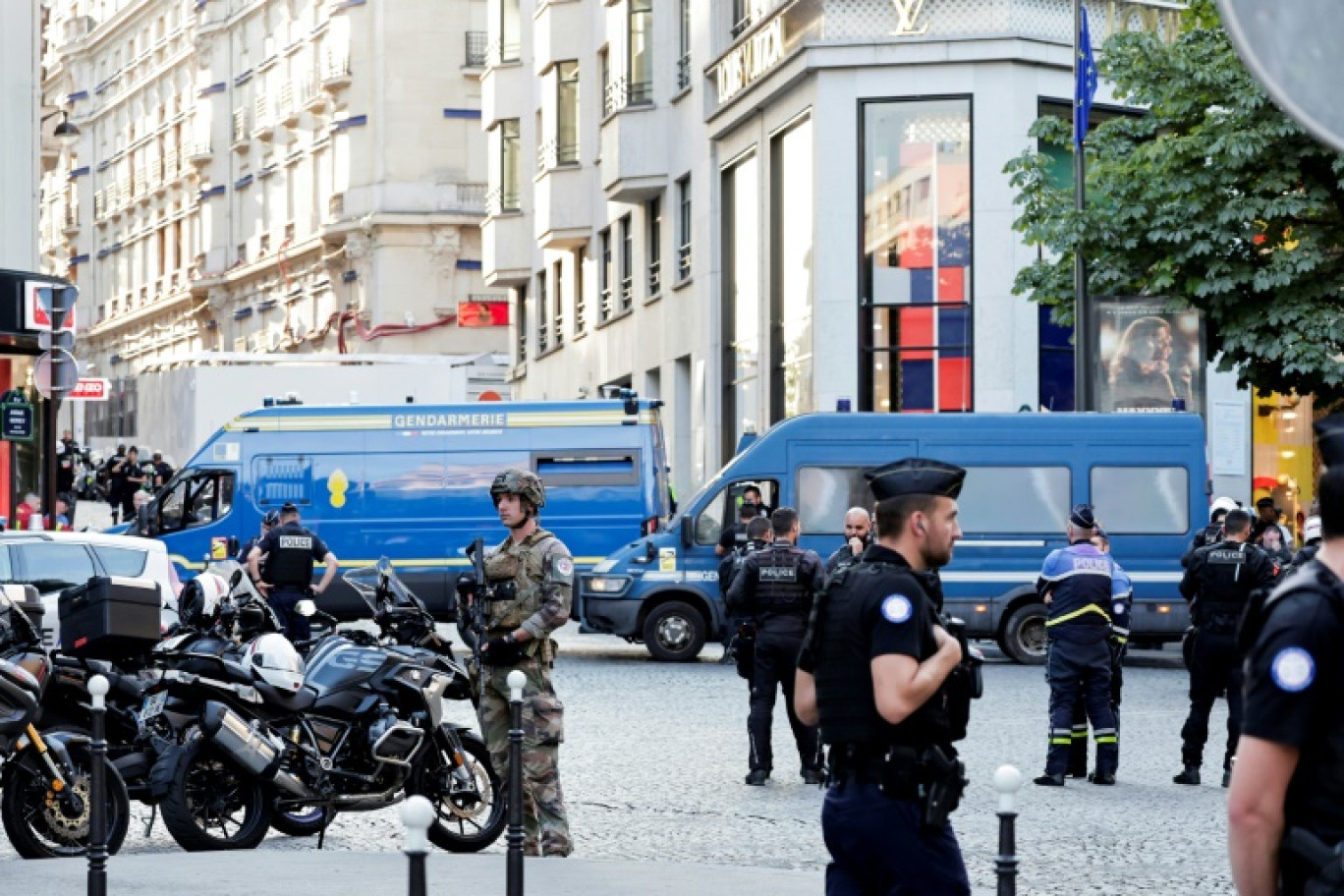 Des policiers, des gendarmes et un soldat sécurisent la zone devant une boutique Louis Vuitton après qu'un homme a attaqué un policier avec un couteau, sur les Champs-Elysées, à Paris, le 18 juillet 2024 © STEPHANE DE SAKUTIN