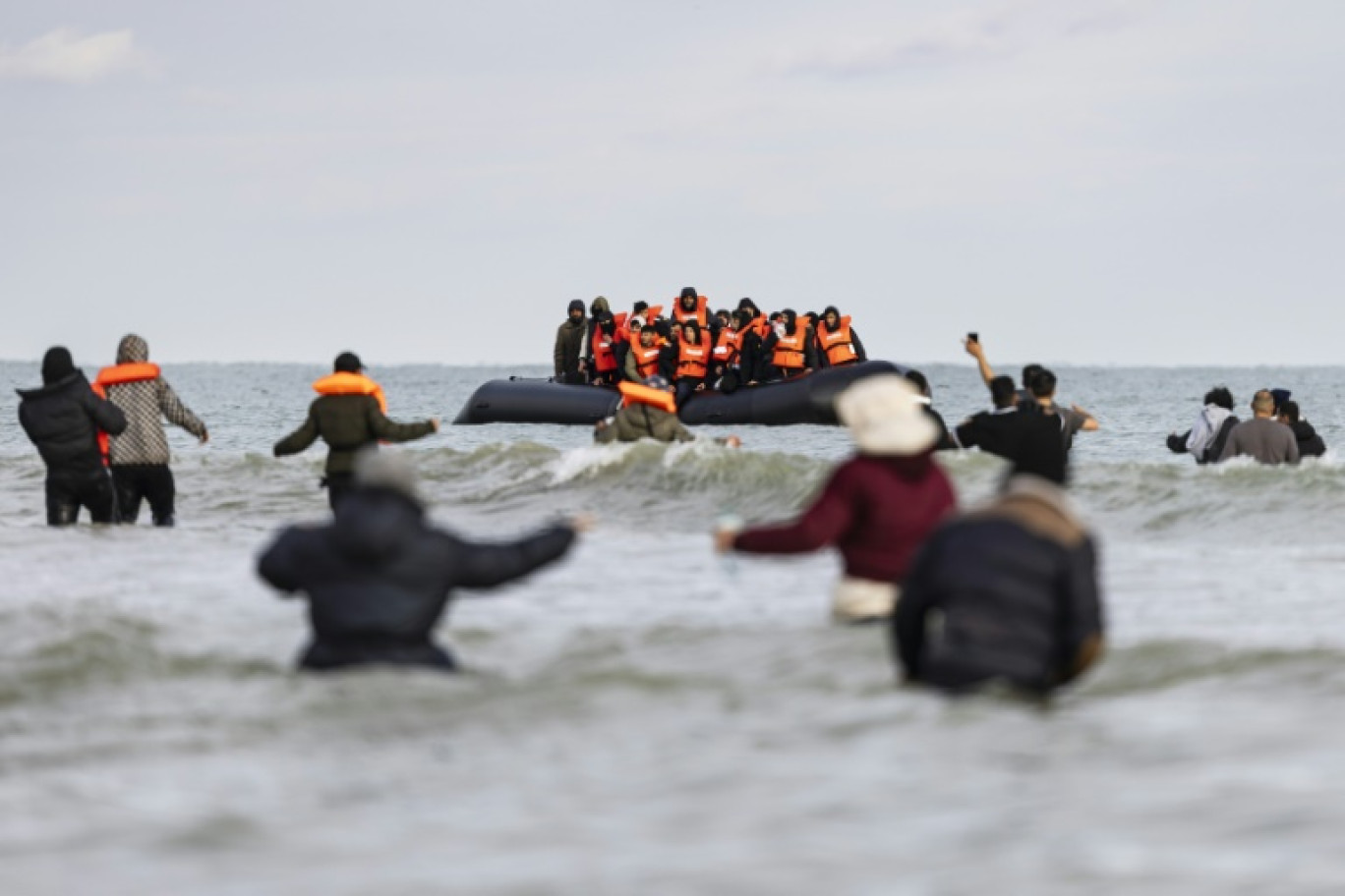 Des migrants se dirigent vers un bateau de passeurs pour tenter de traverser la Manche, sur la plage de Gravelines, près de Dunkerque (Nord) le 26 avril 2024 © Sameer Al-DOUMY