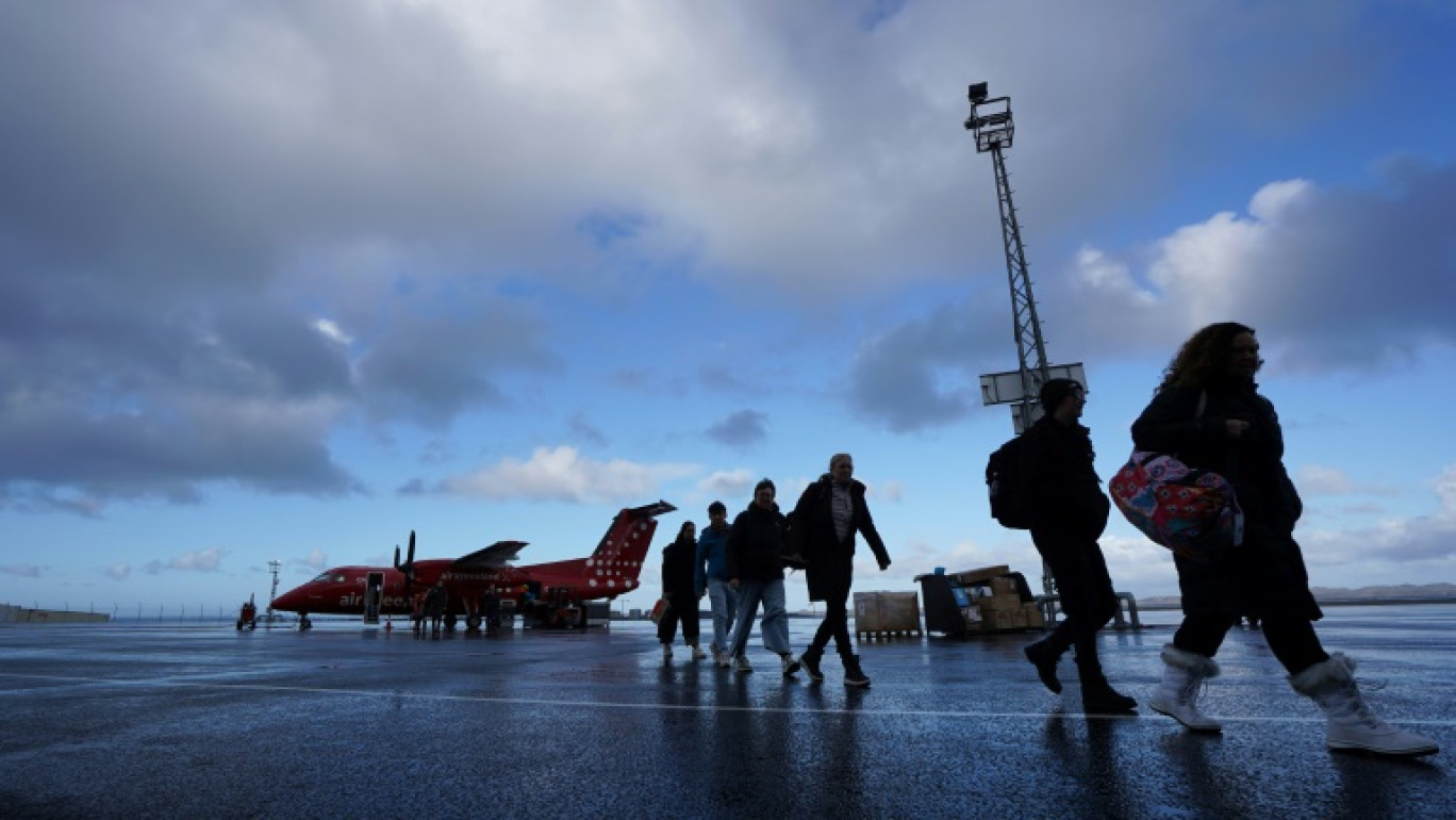 Des passagers débarquent à l'aéroport de Nuuk, au Groenland, le 29 août 2024 © James BROOKS