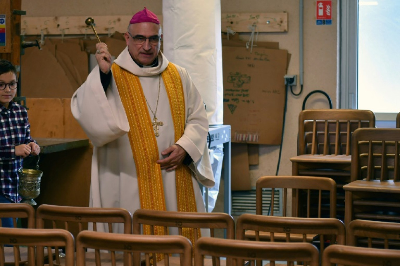 L'évêque du diocèse d'Aire-et-Dax, Mgr Nicolas Souchu, bénit les nouvelles chaises de Notre-Dame de Paris, signées de la designer Iona Vautrin, le 18 novembre 2024 à Hagetmau, dans les Landes © Gaizka IROZ