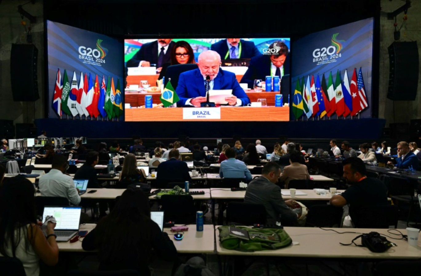 Des journalistes regardent sur un écran le président brésilien Luiz Inacio Lula da Silva pendant le G20 à Rio de Janeiro, le 19 novembre 2024 © Pablo PORCIUNCULA