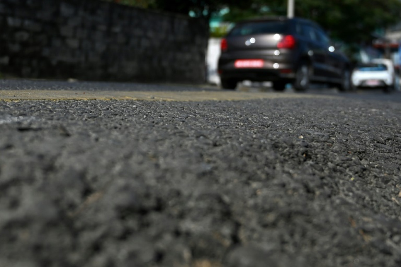 Des voitures roulent sur une route construite à l'aide de déchets plastiques recyclés à Pokhara, au Népal, le 26 décembre 2024 © Prakash MATHEMA