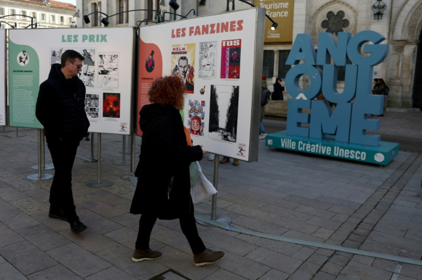 Des visiteurs regardent des affiches dans le cadre d'une exposition lors du 52e Festival international de la bande dessinée d'Angoulême, le 30 janvier 2025 © ROMAIN PERROCHEAU