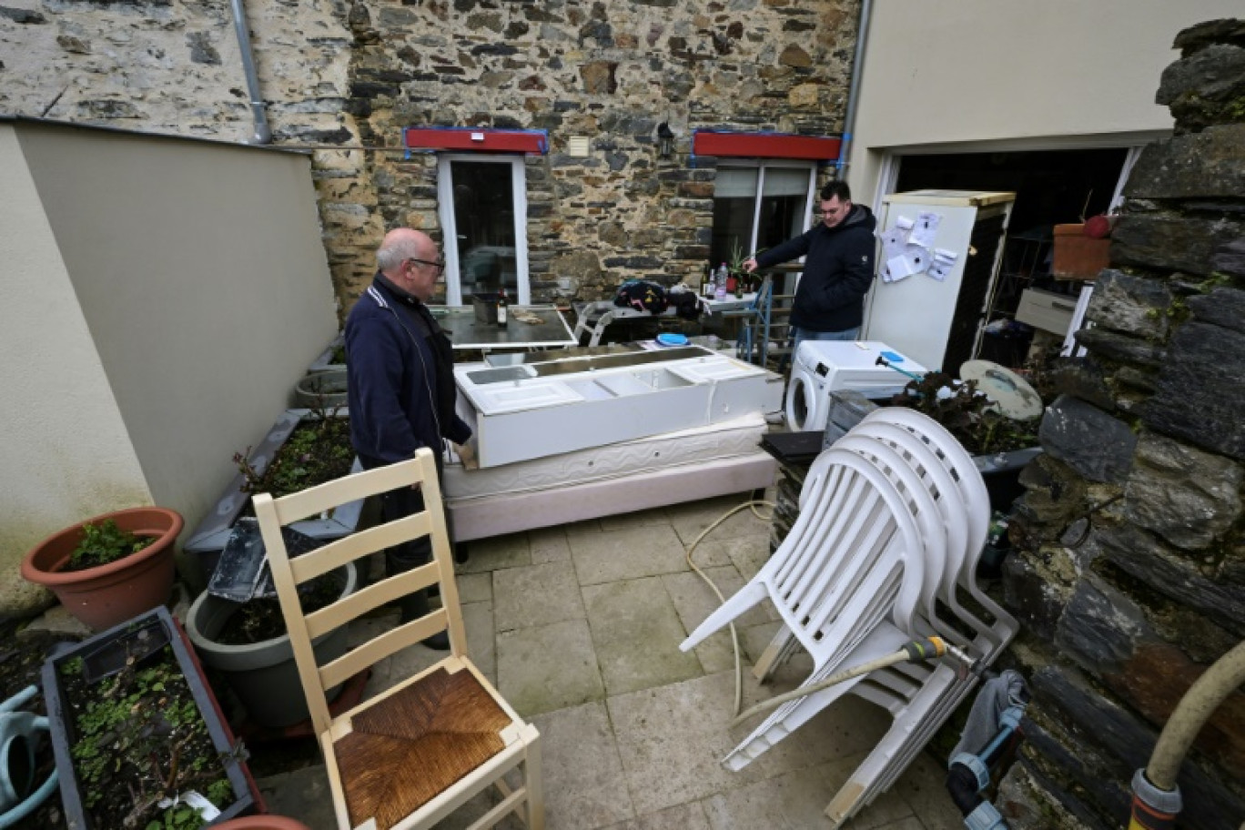 Des habitants de Guipry-Messac nettoient leur maison après les inondations, le 3 février 2025 © Damien MEYER