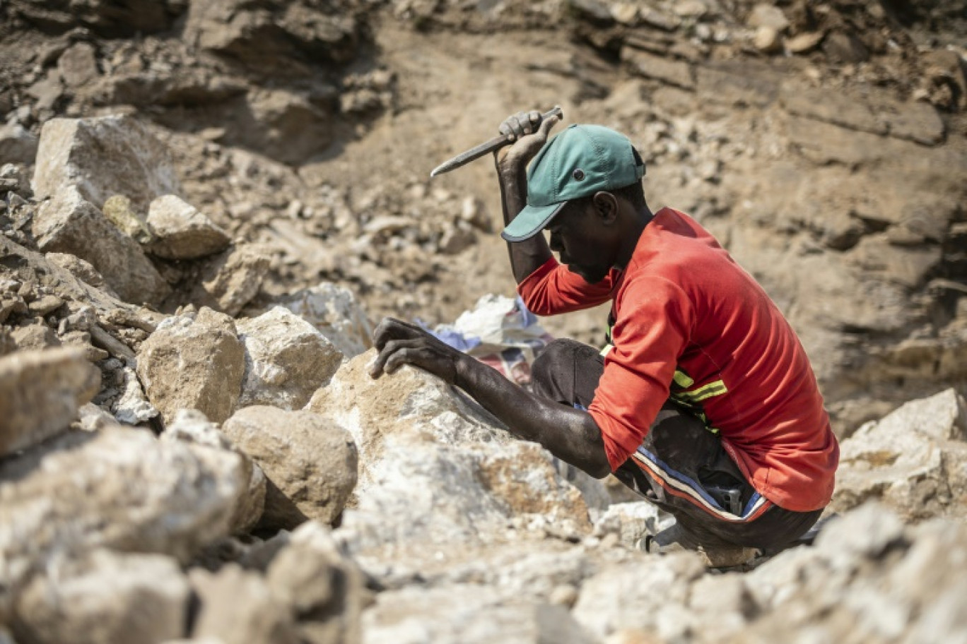 Un mineur utilise un burin pour fendre des pierres contenant du lithium sur un site minier à Gidan Kwano, dans l'État de Nasarawa, le 23 janvier 2025 au Nigeria © OLYMPIA DE MAISMONT