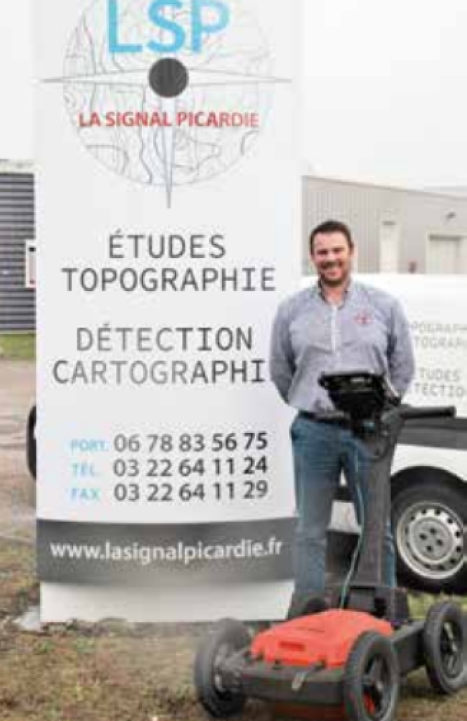 Camille Capellier devant un géo radar servant pour les réseaux de gaz, d’assainissement et d’eau potable.